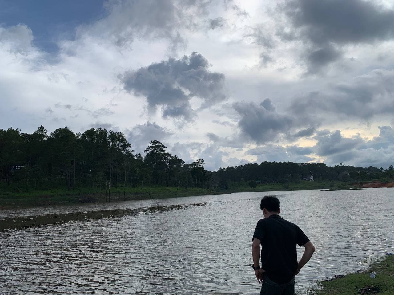 SOKNA CHUN standing beside a forest lake